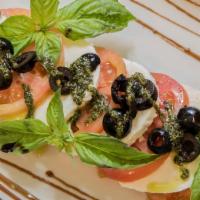 Insalata Caprese · Fresh Mozzarella & Tomatoes, Basil, Black Olives, and Drizzled with Olive Oil, Balsamic & Bl...