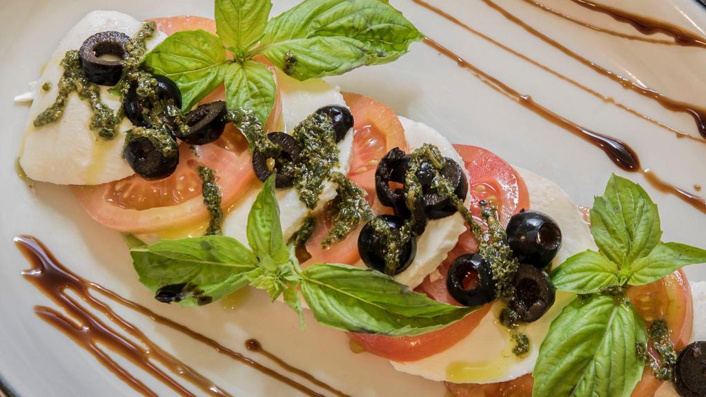 Insalata Caprese · Fresh Mozzarella & Tomatoes, Basil, Black Olives, and Drizzled with Olive Oil, Balsamic & Black Pepper