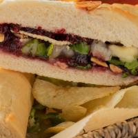 Baghetta Di Formaggio · Baghetta bread, melted Brie Cheese, Raspberry Jam, Lettuce & Roasted Sliced Almonds.