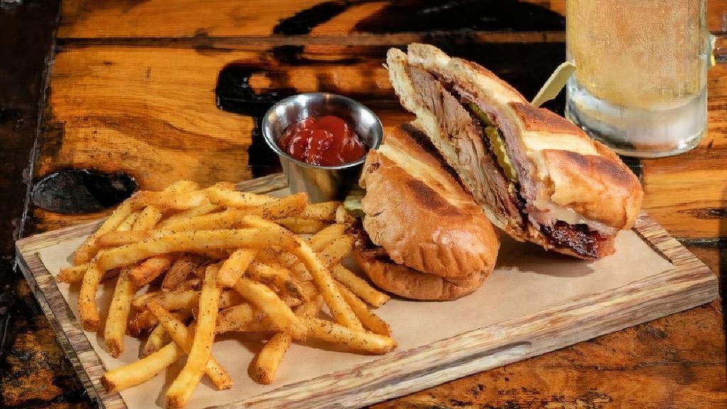 Smoked Pork Cubano · sliced ham · in-house smoked pork · Swiss · pickles · beer mustard · chipotle mayo · served with seasoned French fries
