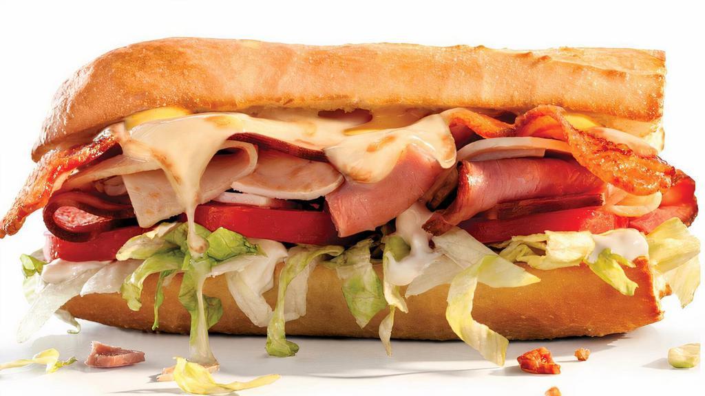 Snack Size Club Grilled · Smoked ham, oven-roasted turkey breast, thick-cut smoked bacon, Swiss, lettuce, Roma tomatoes, honey mustard, mayo.