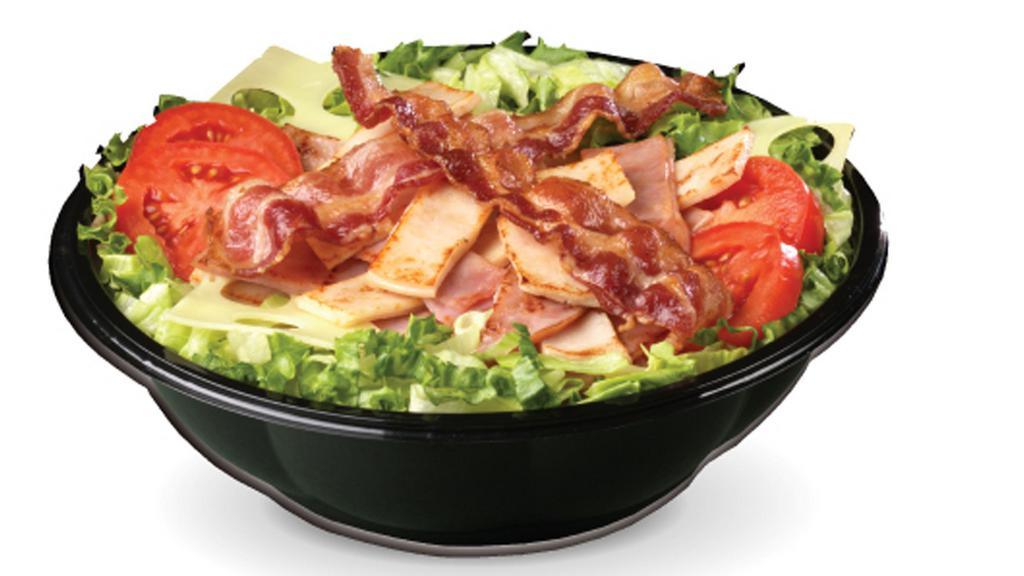 Grilled Club Salad · Lettuce, Roma tomatoes, Smoked ham, oven-roasted turkey breast, thick-cut smoked bacon, Swiss.