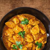United Chicken Curry · Tender morsels of chicken cooked in a classic brown curry with Indian whole spices served wi...