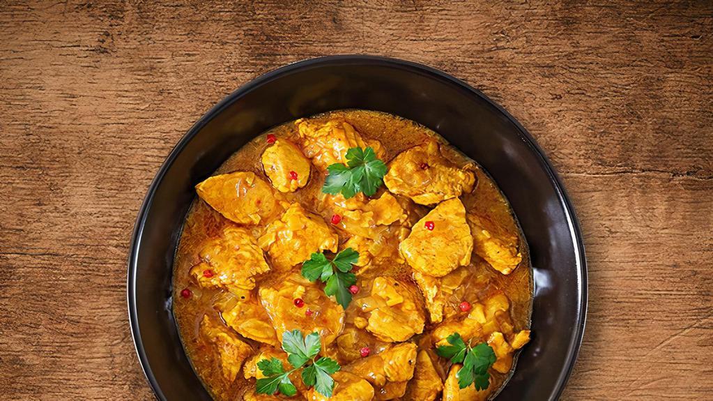 United Chicken Curry · Tender morsels of chicken cooked in a classic brown curry with Indian whole spices served with a side of aromatic basmati rice