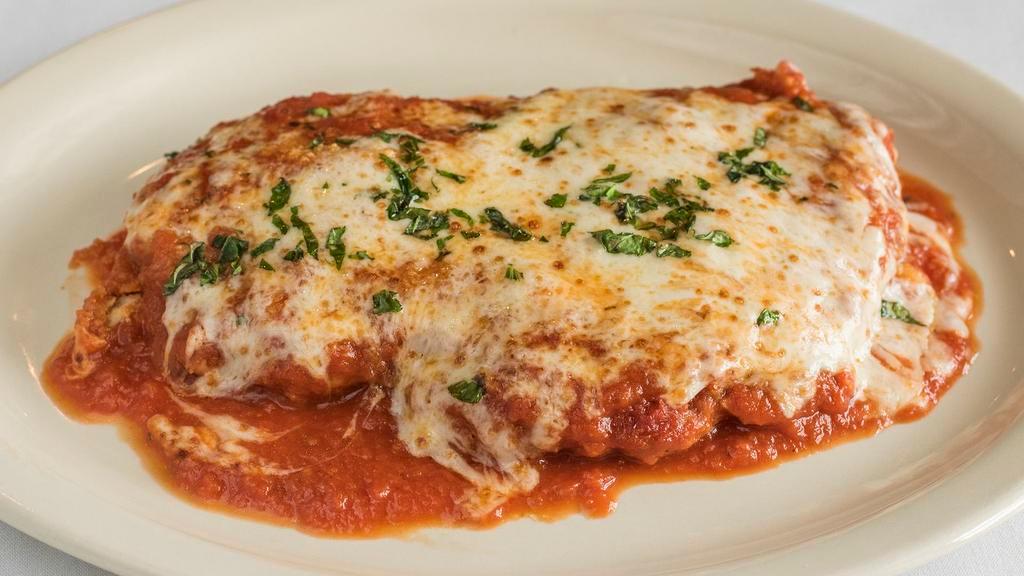 Chicken Parmesan · Italian breaded fried chicken baked with ricotta, fresh basil, Amici marinara, and provolone served with spaghetti.