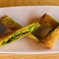 Avocado Cilantro Egg Rolls · Homemade and lightly fried to perFection and served with a Santa Fe ranch and sweet and spic...