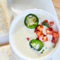 Queso · Our white cheese dip topped with jalapeños and pico de gallo. Served with tortilla chips or ...