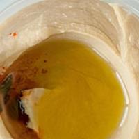 Traditional Hummus · Chickpeas, tahini sauce, garlic, and fresh lemon juice. Served with pita bread.