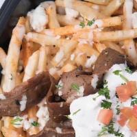 Loaded Fries · Seasoned Fries, crumbled Feta, tahini & garnish. Loaded on top with traditional gyro meat