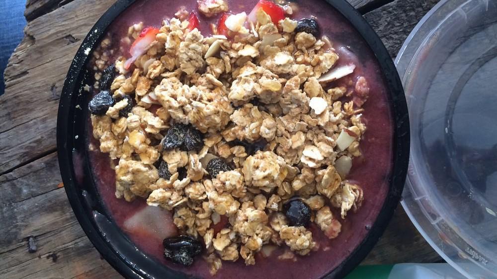 Acai Bowl · Brazilian acai, banana, strawberries, blueberries, organic granola, honey and coconut flakes.
