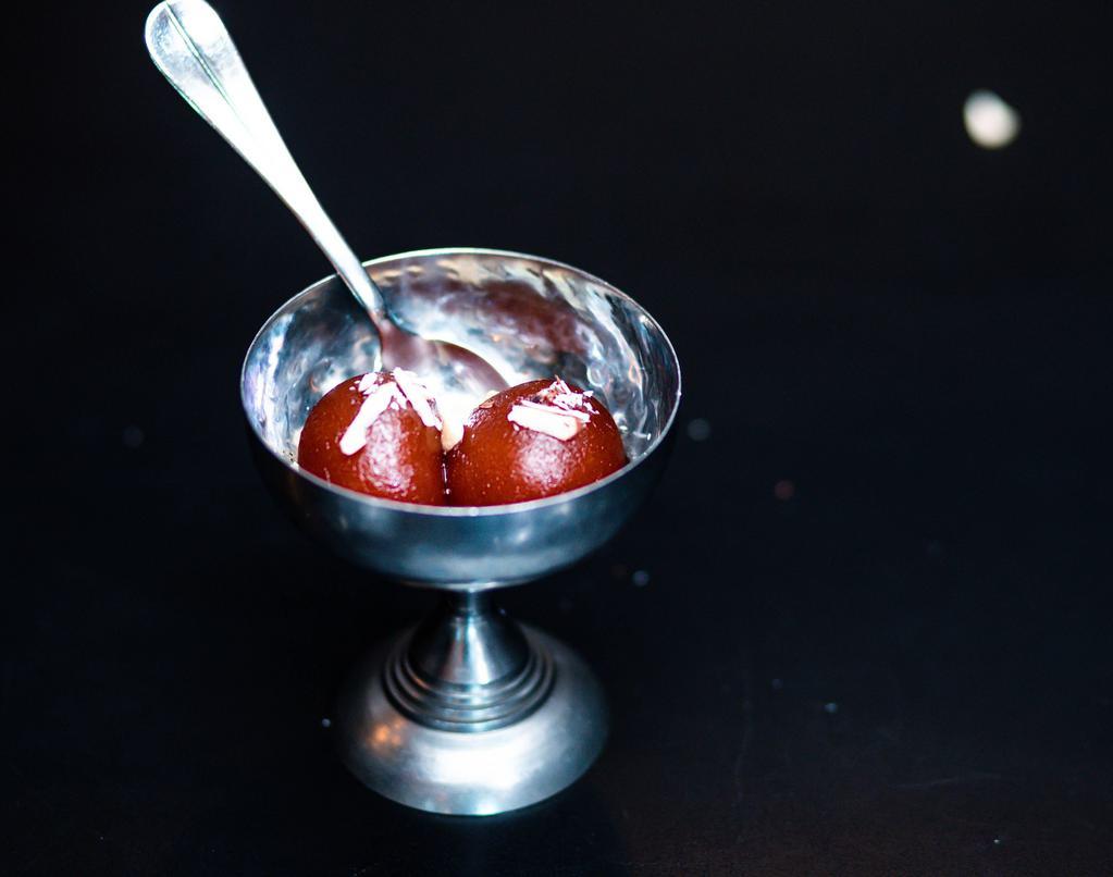 Gulab Jamun · Brown balls made with wheat flour and milk soaked in sugar syrup.