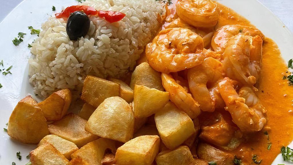 Camaroes Ao Creme De Alho · Shrimp in a creamy Pink Garlic Sauce served with Rice and fried Potatoes
