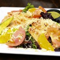 Ensalada Tropical · Fresh spring mix salad topped with slices of oranges, tomatoes, avocado, crumbled cheese and...