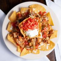 Fajita Nachos · Served with cheese dip, peppers, onions and a side of lettuce, tomatoes and sour cream.