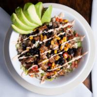 Cantina Bowl · Grilled chicken or steak served over a bed of Mexican yellow rice, fresh lettuce, black bean...
