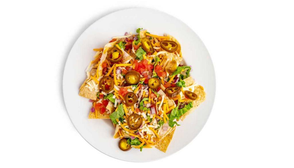 Nachos Supreme · A mountain of fresh tortilla chips smothered in chili and queso cheese, topped with lettuce, tomatoes, onions, shredded cheese, jalapeño and served with sour cream add pork.