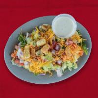 Side Salad · Mixed greens, diced cucumbers, red onion, and tomatoes, topped with croutons, shredded chedd...
