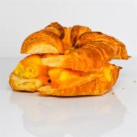 Egg And Cheddar Croissant Sandwich · 2 fresh cracked cage-free scrambled eggs, melted Cheddar cheese, and Sriracha aioli on a war...