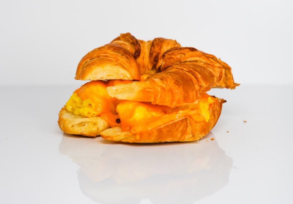 Egg And Cheddar Croissant Sandwich · 2 fresh cracked cage-free scrambled eggs, melted Cheddar cheese, and Sriracha aioli on a warm croissant