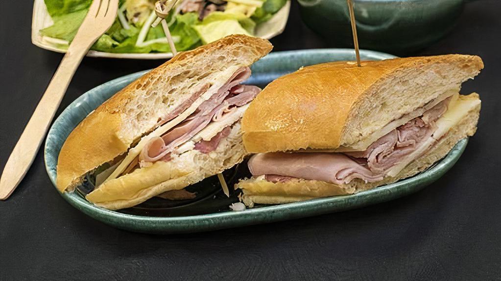 Iberico Sandwich · Ham, prosciutto, and manchego cheese with a garlic dressing on our French baguette.