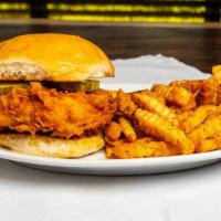 Chicken Sandwich · Crispy fried chicken breast on a brioche bun with tangy sweet Hamilton sauce and pickles, se...