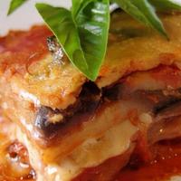 Our Homemade Eggplant Parmigiana · Baked in our hot pizza oven with 4 layers of eggplant and our parmigiana sauce. Served with ...