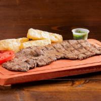 Carne Asada · Grilled steak, with your choice of one side, one slice of tomato, and chimichurri.