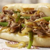 Philly Cheese Steak · Thinly sliced sirloin steak, grilled to perfection, mixed with caramelized onions and green ...
