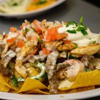 Nachos Texanos · Steak, chicken and shrimp.