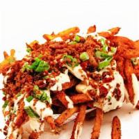 Loaded Fries · Our Classic Fries Served With Queso Blanco, Bacon, and Green Onions