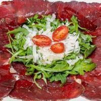 Carpaccio Di Bresaola · Italian cured meat with arugula, shaved Parmesan cheese, lemon juice, EVOO and black pepper.