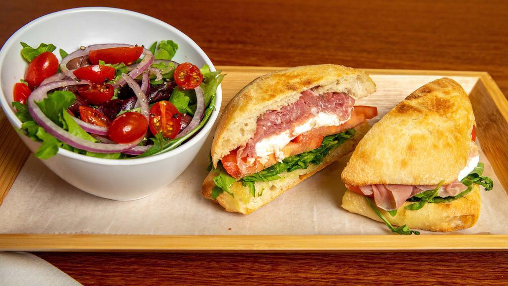 Prosciutto Mozzarella Panini · Fresh mozzarella cheese, sliced tomatoes, arugula and prosciutto di Parma.