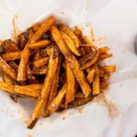 Tangy Fries · Tossed in our signature sauce garnished with lemon pepper seasoning.