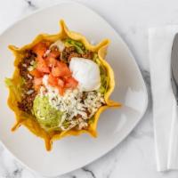 Taco Salad · Seasoned shredded beef or chicken served on a bed of lettuce topped with guacamole, tomato, ...