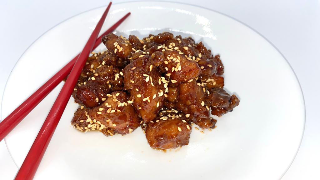 Sesame Chicken · Wok-fried chicken tossed in a sweet brown sugar glaze, topped with sesame seeds.
