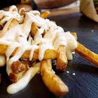 Truffle Fries · French-seasoned hand-cut fries with truffle mayo, fresh herbs and Parmesan.