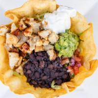 Taco Salad · Large crispy flour tortilla shell filled with shredded chicken or ground beef, lettuce, shre...