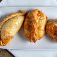 Empanadas Argentinas · Choice of three: chicken, beef, spinach, ham and cheese, or onion and cheese.