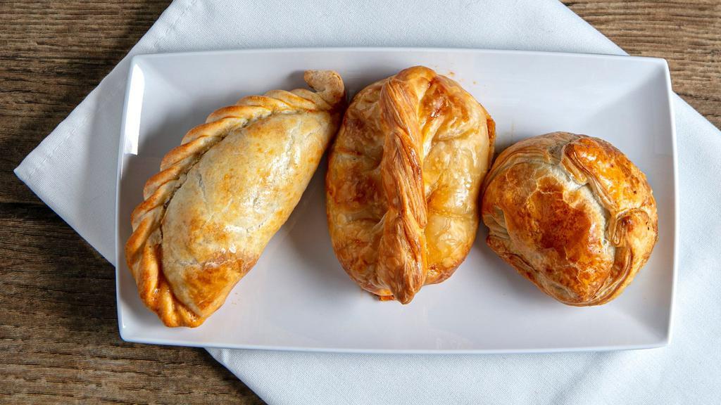 Empanadas Argentinas · Choice of three: chicken, beef, spinach, ham and cheese, or onion and cheese.
