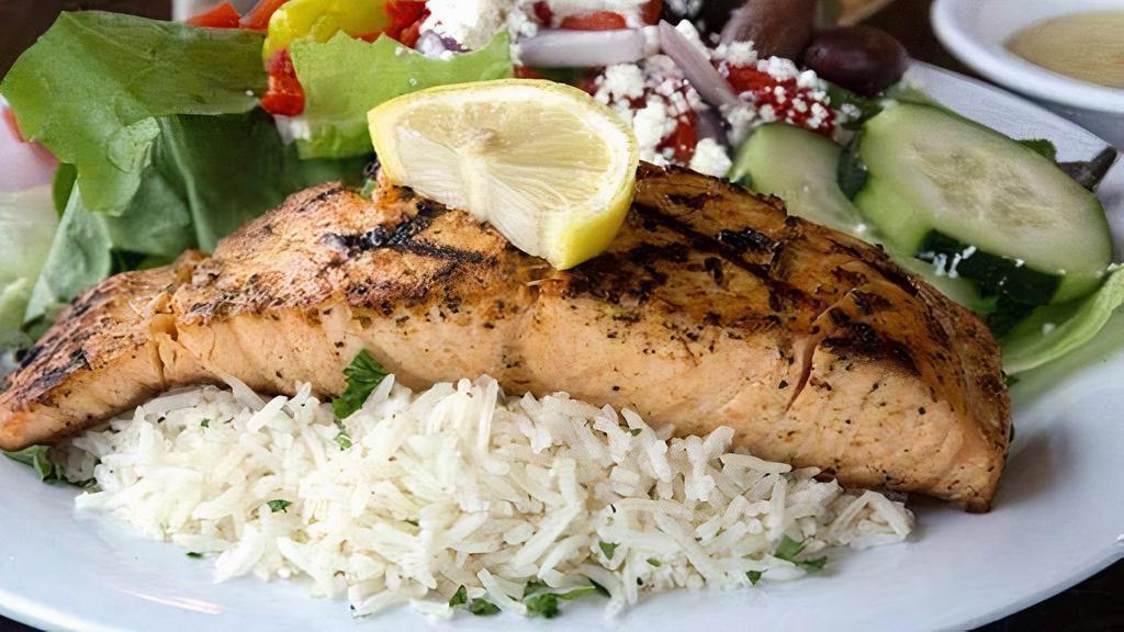 Grilled Salmon Feast · Atlantic salmon, seasoned, and chargrilled. Served with Greek salad and your choice of roasted new potatoes or basmati rice.