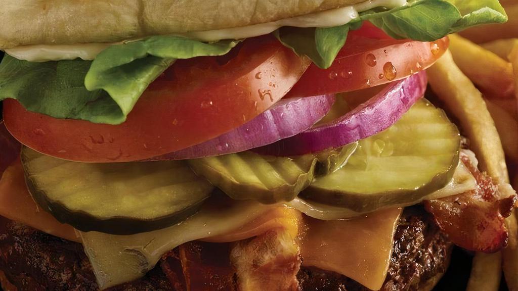 The Ultimate Bacon Cheeseburger · Cheddar and pepper jack cheese, 3 strips of bacon, lettuce, tomato, pickles, onion and mayo..