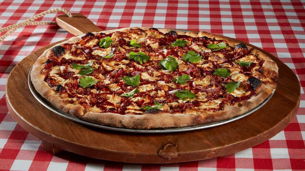 Bbq Chicken Pizza · A spin on our traditional pizza with Sweet Baby Ray’s Barbecue Sauce, chicken, smoky bacon, red onion and garnished with fresh cilantro.