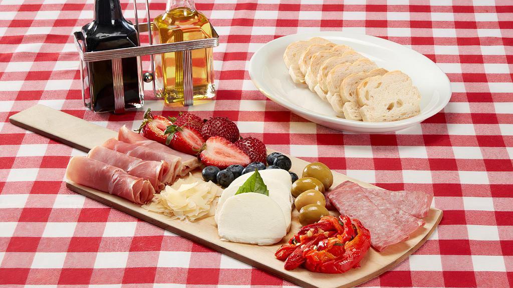The Bridge Board · Our play on a charcuterie board, featuring a generous assortment of Italian meats, cheeses, colorful antipasto and fresh berries. Served with sliced bread.