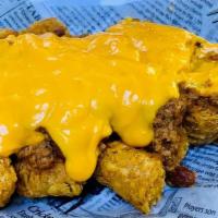 Nach-Ja Tots · Tater Tots topped with our home chili and nacho cheese.