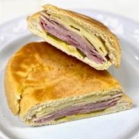 Cuban Sandwich / Sandwich Cubano (8477) · Ham, roast pork, Swiss cheese, pickles & mustard on Cuban bread roll. / Jamon ahumado, piern...