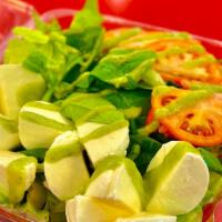 Caprese Salad · Chopped fresh lettuce, tomato, fresh mozzarella, and pesto seasoning. With choice of dressing.
