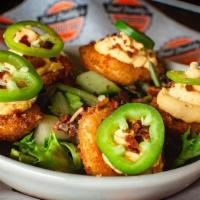 Not Your Mama'S Deviled Eggs · Five lightly fried deviled eggs with a spicy filling, crumbled bacon & garnished with a fres...