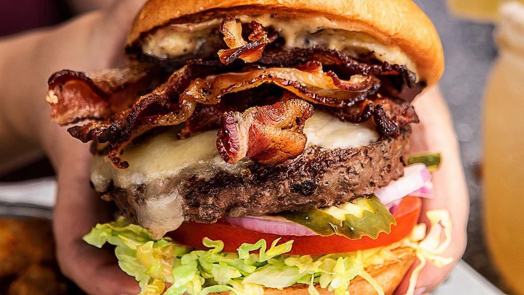 Bacon Cheeseburger On Steroids* · Monterey Jack cheese, three pieces of jalapeño bacon, three pieces of applewood smoked bacon, housemade bacon mayo, shredded iceberg lettuce, tomato, red onion & pickles
