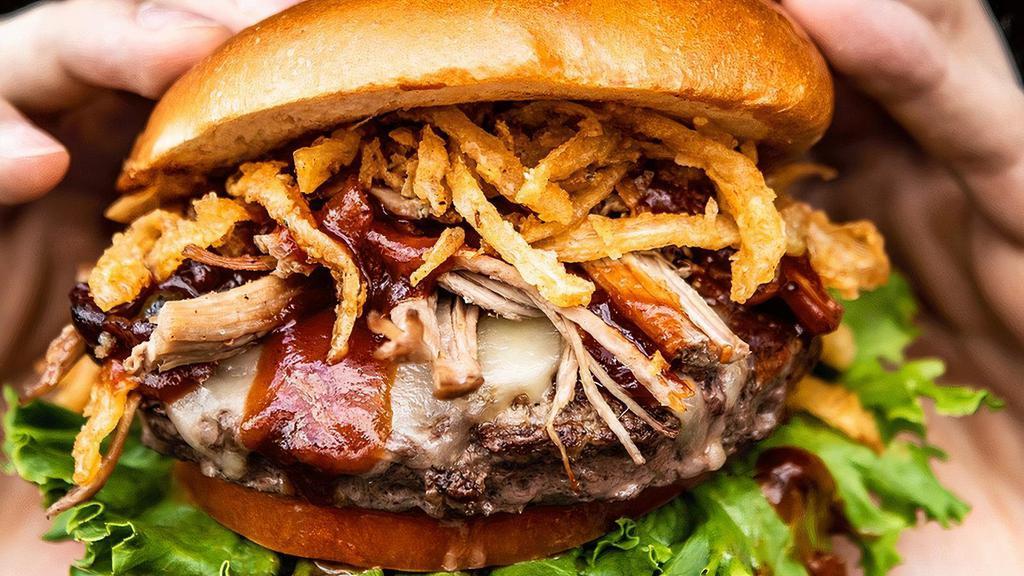 Smokehouse Burger* · Pulled pork, pepper jack cheese, onion straws, lettuce, tomato & BBQ sauce