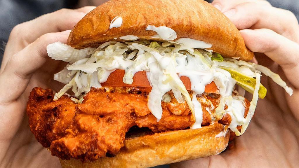 Buffalo Chicken · Crispy or grilled chicken breast tossed in buffalo sauce with blue cheese crumbles, our house jalapeno ranch dressing, shredded iceberg lettuce, tomato & pickles